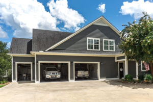 Photo of a house with cars parked in the garages