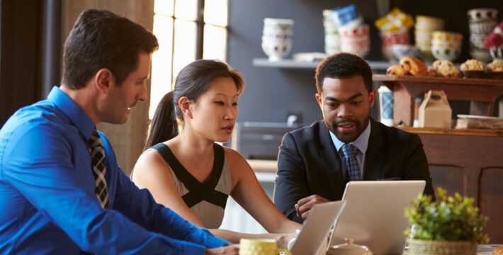 Photo of business owners reviewing insurance information on computers