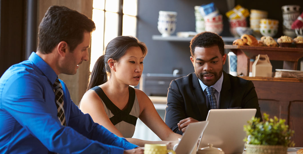 Photo of business owners reviewing insurance information on computers