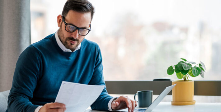 Image of a businessman reviewing his employee benefits program documents