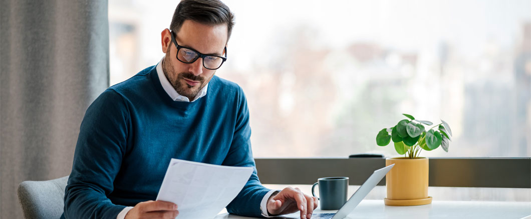 Image of a businessman reviewing his employee benefits program documents