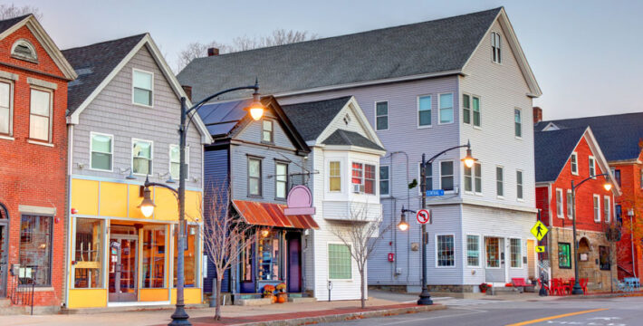 Image of a small-town Main Street with local shops and brick commercial buildings