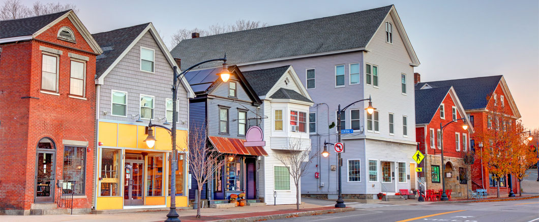 Image of a small-town Main Street with local shops and brick commercial buildings