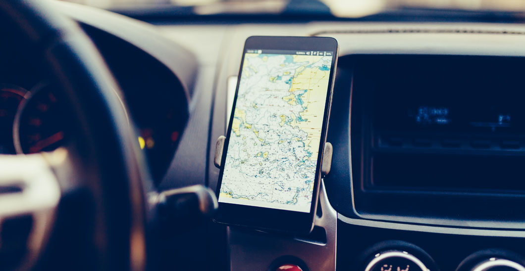 A photo of a cell phone being used hands-free in a vehicle