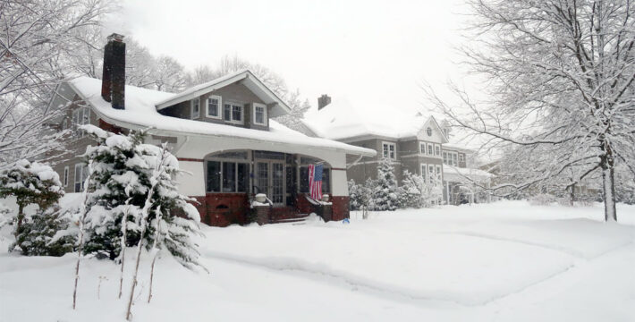 Exterior image of a snow-covered New England home in winter