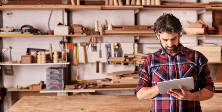 Photo of a business owner viewing content on a tablet device