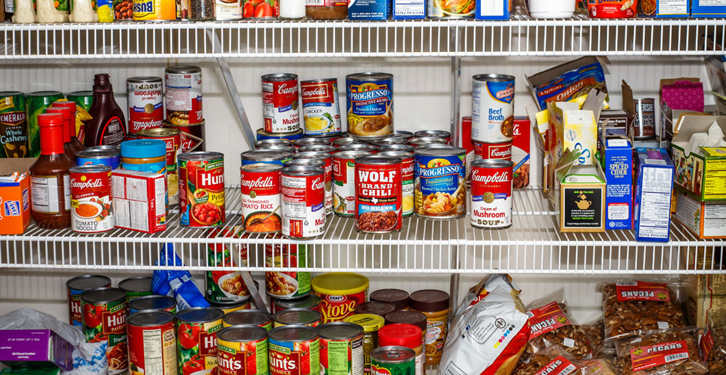 A photo of a food pantry with canned goods displayed