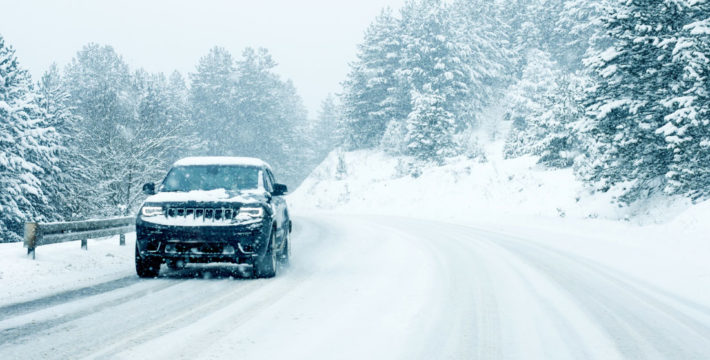 Photo of a Jeep driving on a snowy road