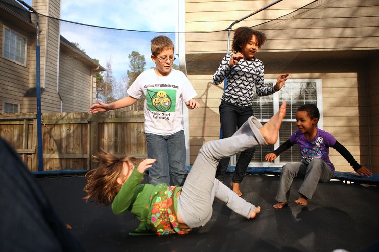 Kids playing on a trampoline, demonstrating the value in having umbrella insurance in South Shore MA
